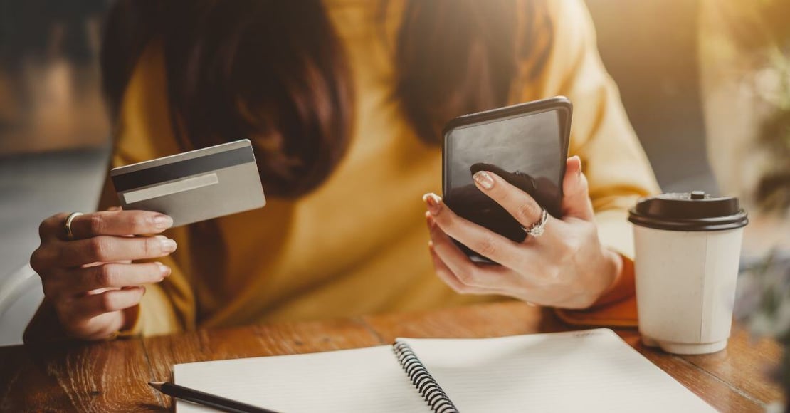 Woman making credit card payment on her phone