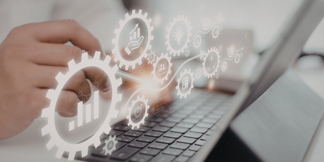 A business-themed graphic showing an open hand supporting a stylized declining bar chart, a downward arrow with a percentage symbol, and a dollar sign, all representing reduced costs. The background features a blurred cityscape and geometric patterns, creating a modern, financial-technology look.