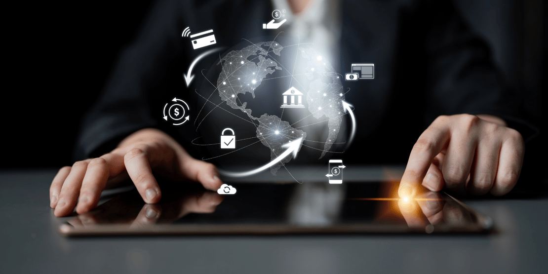 Business person using a digital tablet with glowing global network and finance icons overlayed.