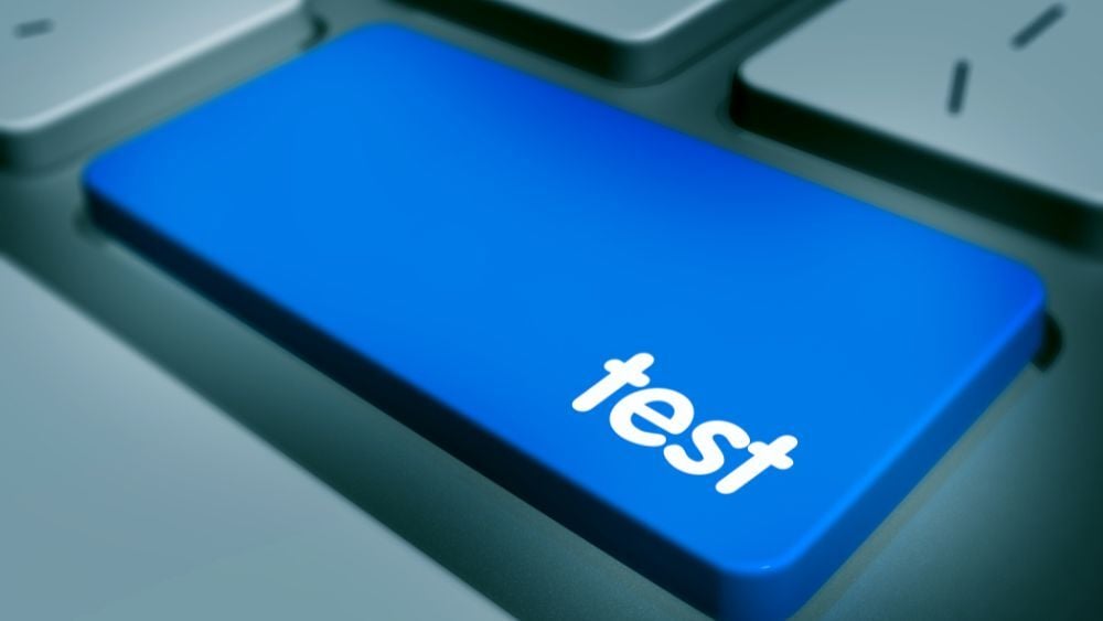 The image is zoomed in on a keyboard with a large blue button that has the word 