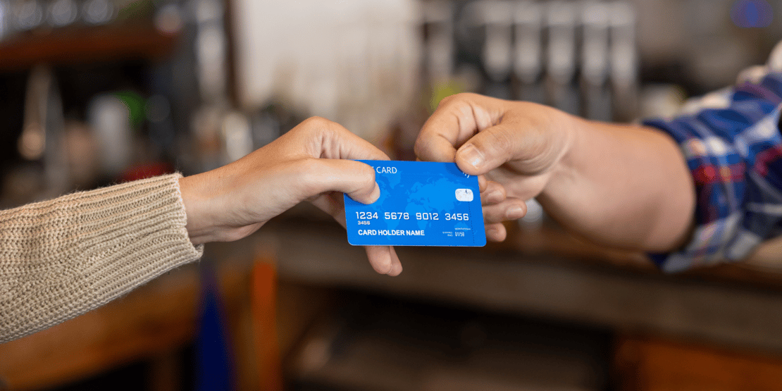two-people-holding-credit-card